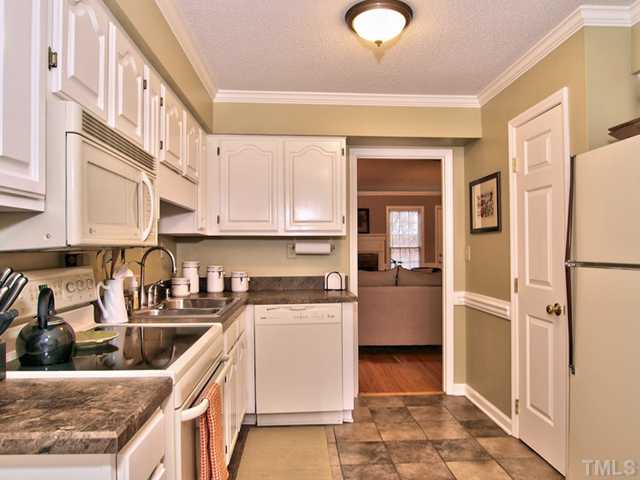 4527 Hershey Court Raleigh, NC 27613 - Photo 6 of 25 Spacious Kitchen with Beautiful Cabinetry, Tile Floors, Microwave, Smooth Top Stove and Pantry.