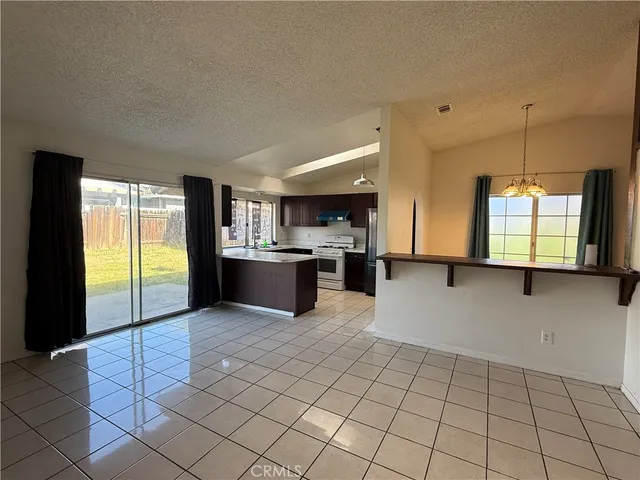 a view of kitchen with granite countertop cabinets and outdoor space
