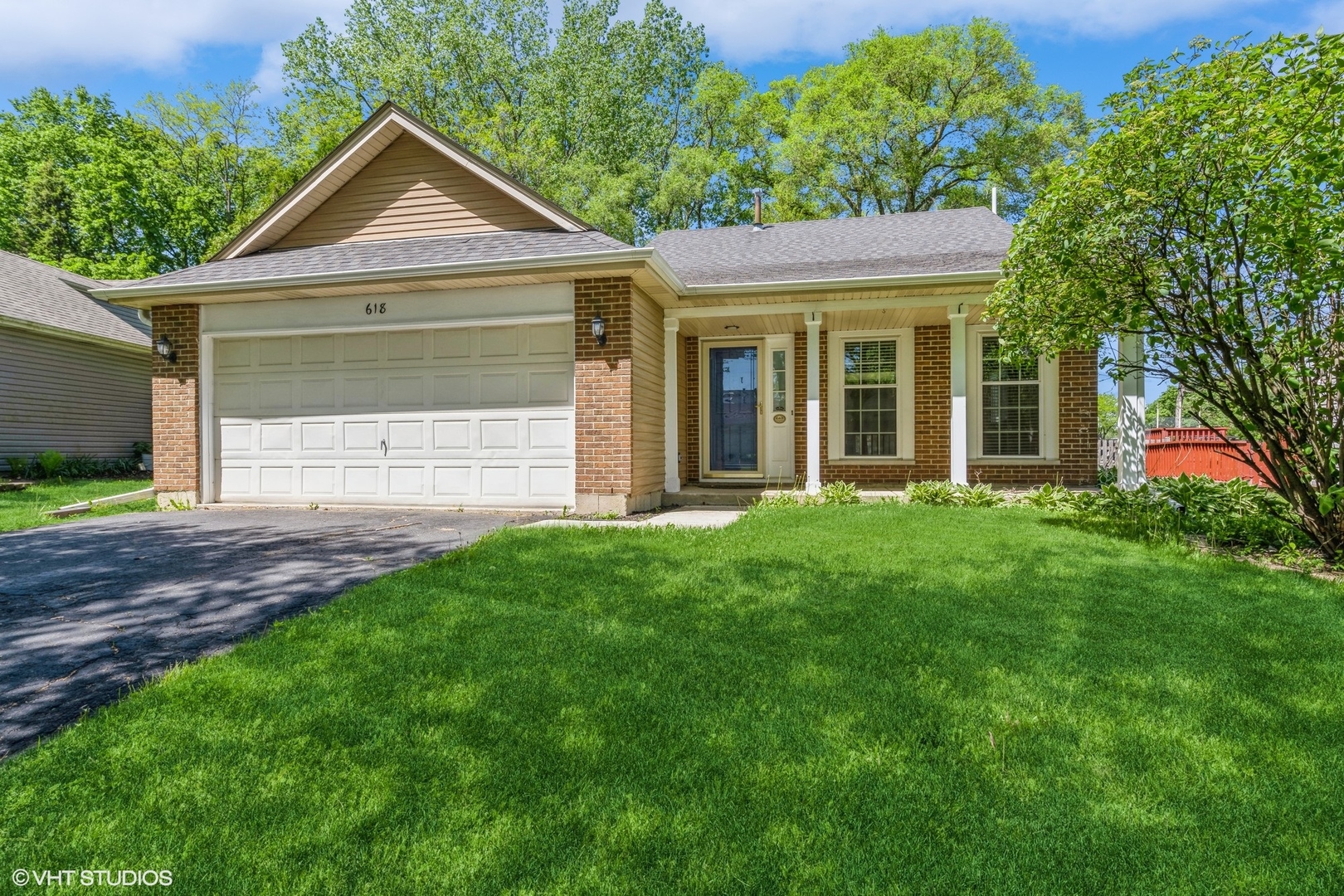 618 Hampton Circle Elgin, IL 60120 - Photo 1 of 18 a front view of a house with a yard and garage