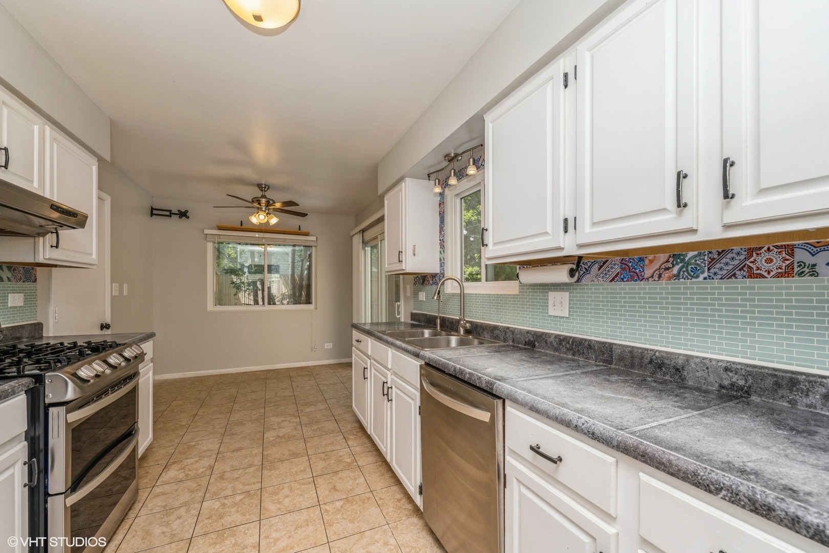618 Hampton Circle Elgin, IL 60120 - Photo 4 of 18 a kitchen with granite countertop a sink a stove and cabinets
