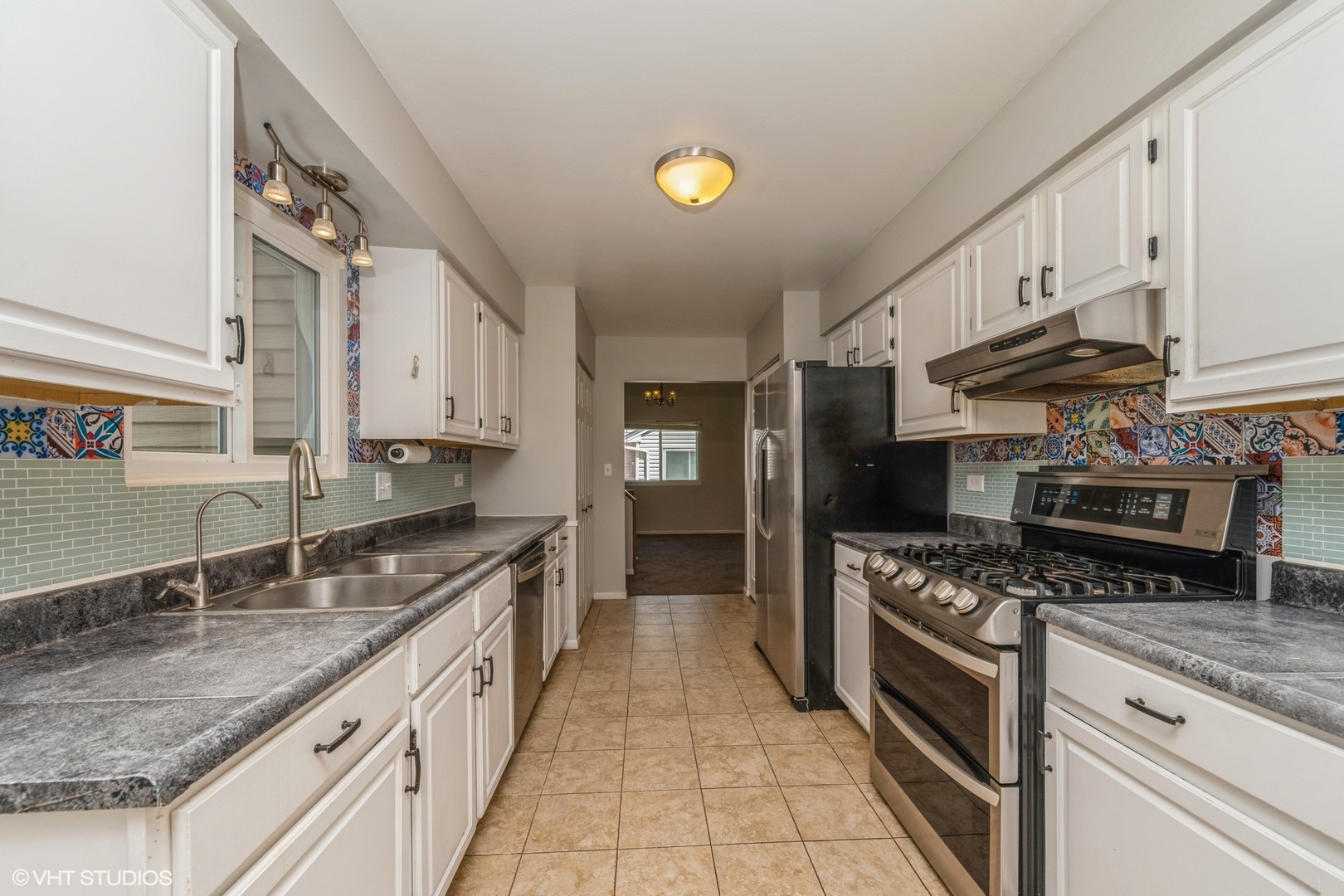 618 Hampton Circle Elgin, IL 60120 - Photo 5 of 18 a kitchen with stainless steel appliances granite countertop a sink stove and refrigerator