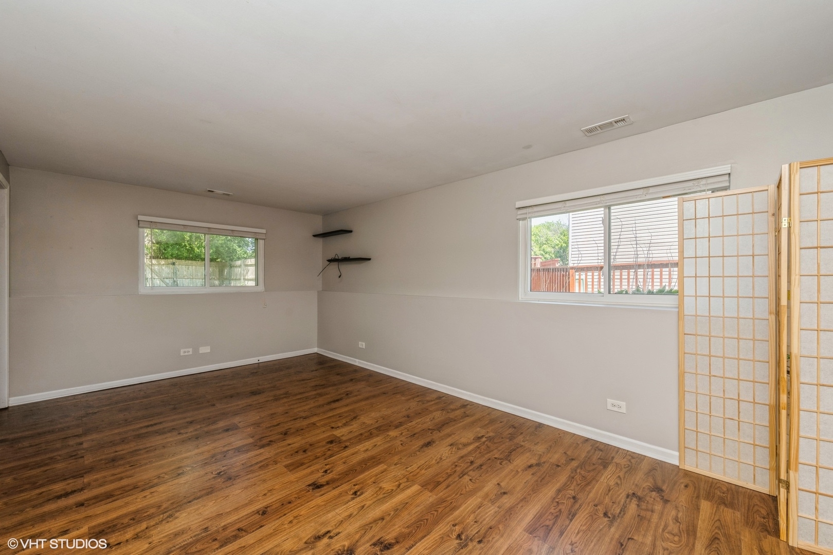 618 Hampton Circle Elgin, IL 60120 - Photo 7 of 18 an empty room with wooden floor and windows