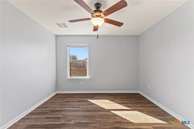 a bedroom with a bed and a potted plant