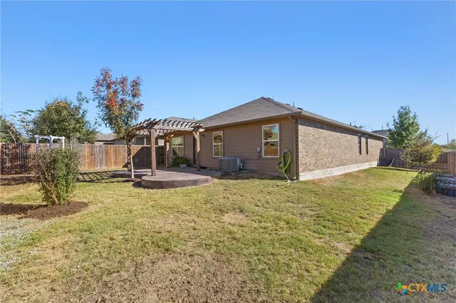 a view of a backyard with a large tree