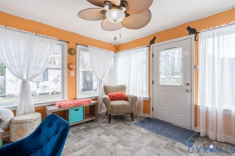 a bedroom with furniture and a large window