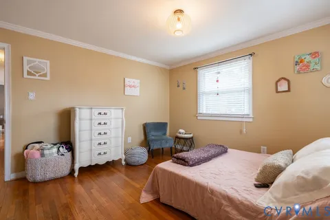 a bedroom with two beds and a window