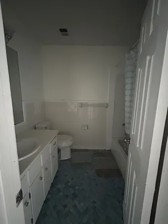 a bathroom with a tub sink and toilet