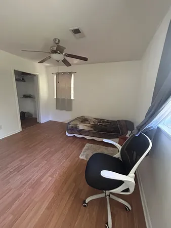 a bedroom with a bed and a chair