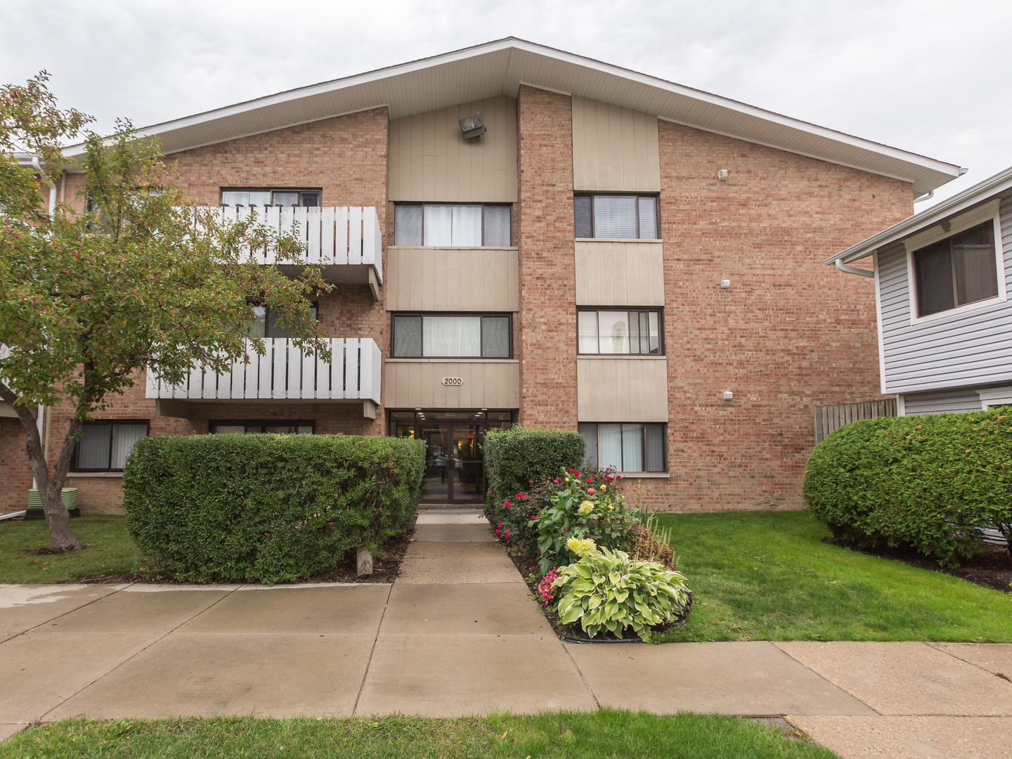 2000 Bayside Drive, Unit 302 Palatine, IL 60074 - Photo 1 of 43 a front view of a house with a yard