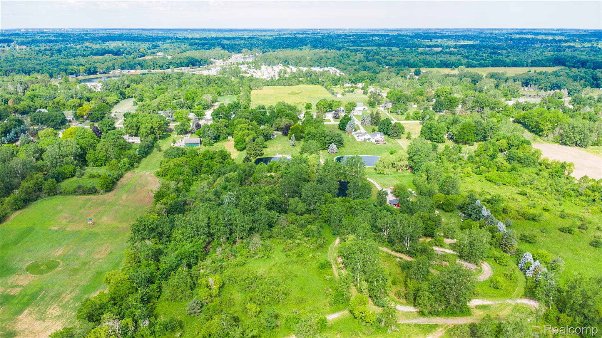 4418 North Gale Road Davison, MI 48423 - Photo 45 of 46 Expansive aerial showcasing a verdant landscape with mature trees, open fields, and scattered residential properties