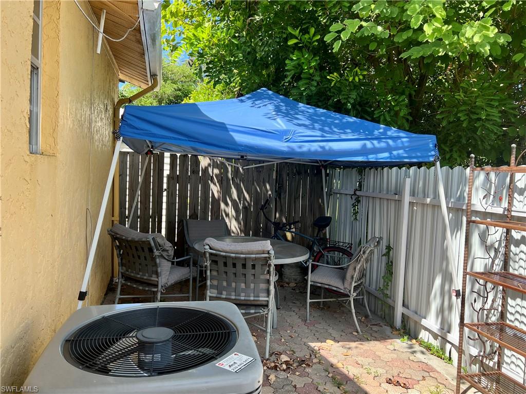 2080 Pelton Avenue Naples, FL 34112 - Photo 20 of 43 a view of patio with table and chairs and potted plants
