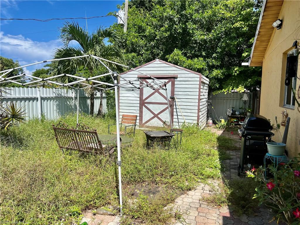 2080 Pelton Avenue Naples, FL 34112 - Photo 32 of 43 a backyard of a house with lots of green space and fountain