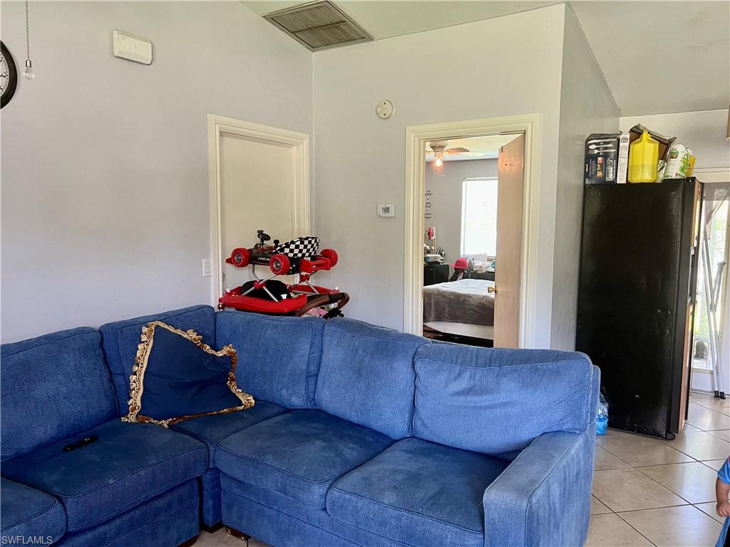 2080 Pelton Avenue Naples, FL 34112 - Photo 34 of 43 a living room with furniture and a flat screen tv