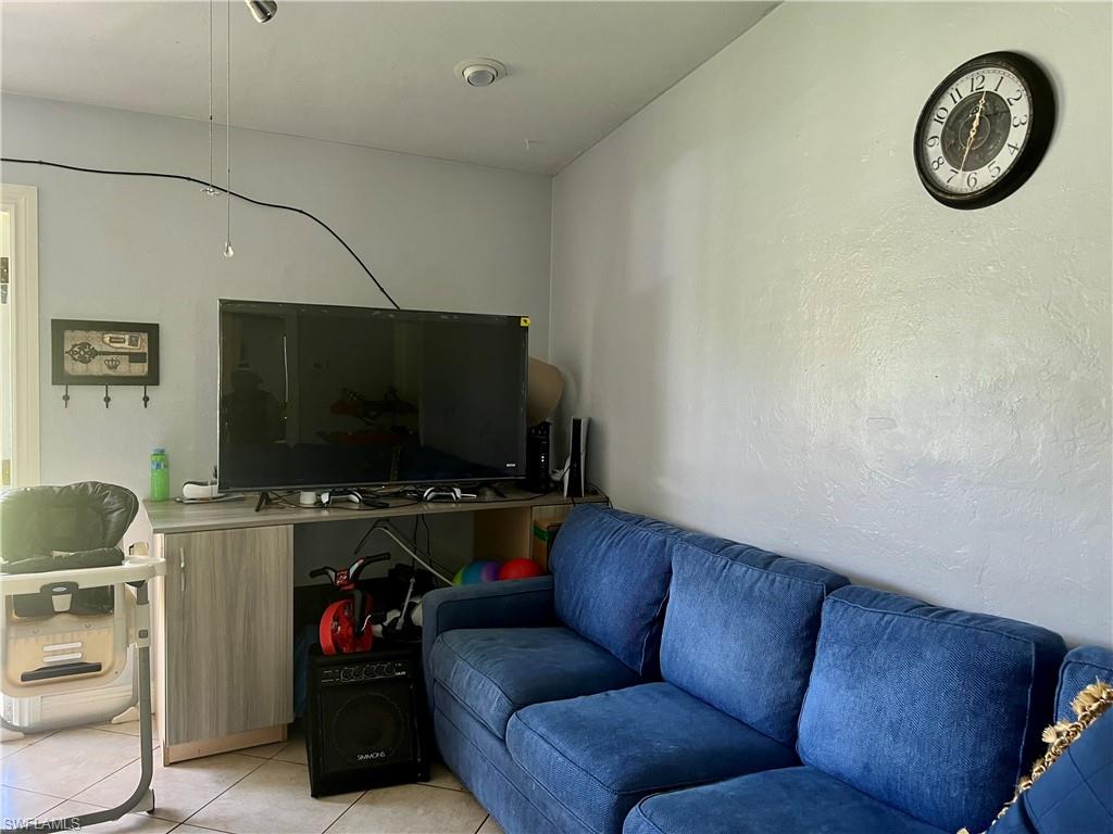 2080 Pelton Avenue Naples, FL 34112 - Photo 35 of 43 a living room with furniture and a flat screen tv