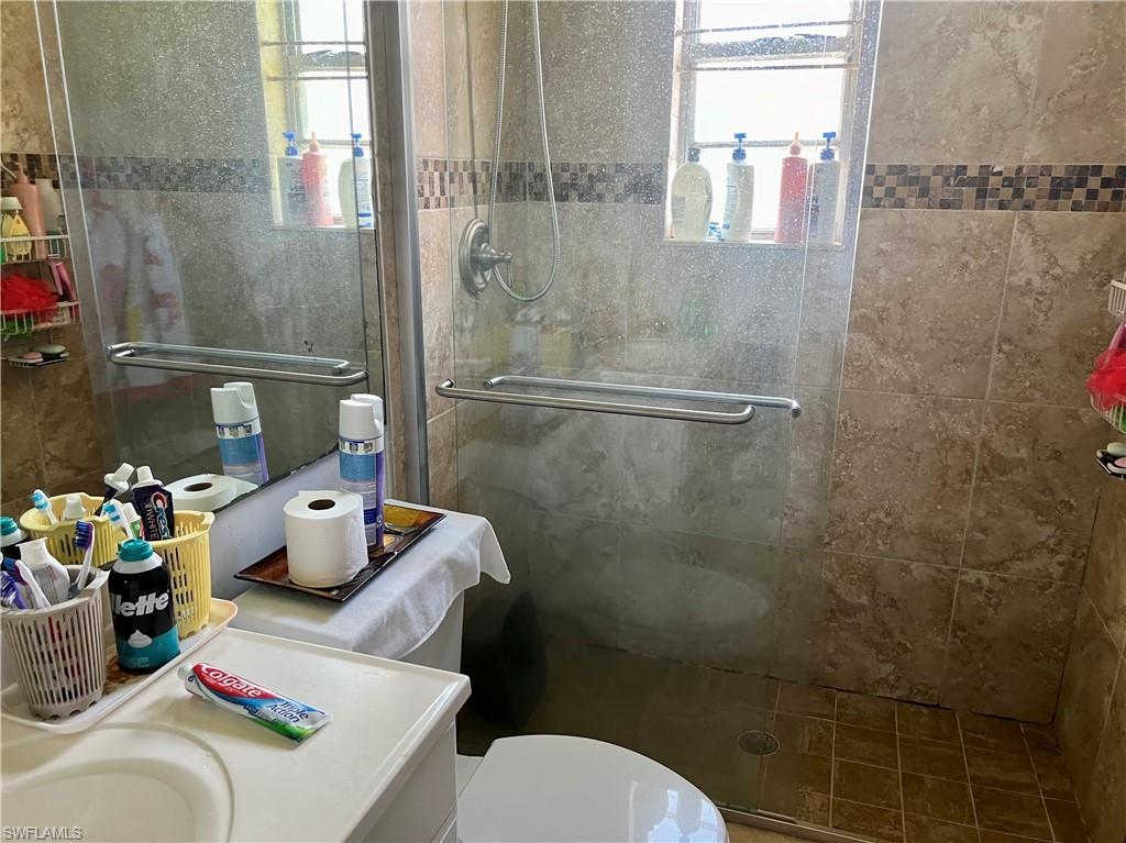 2080 Pelton Avenue Naples, FL 34112 - Photo 40 of 43 a bathroom with a sink toilet and shower