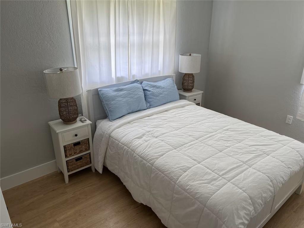 1220 Embassy Lane Naples, FL 34104 - Photo 7 of 11 a bedroom with a bed and a window