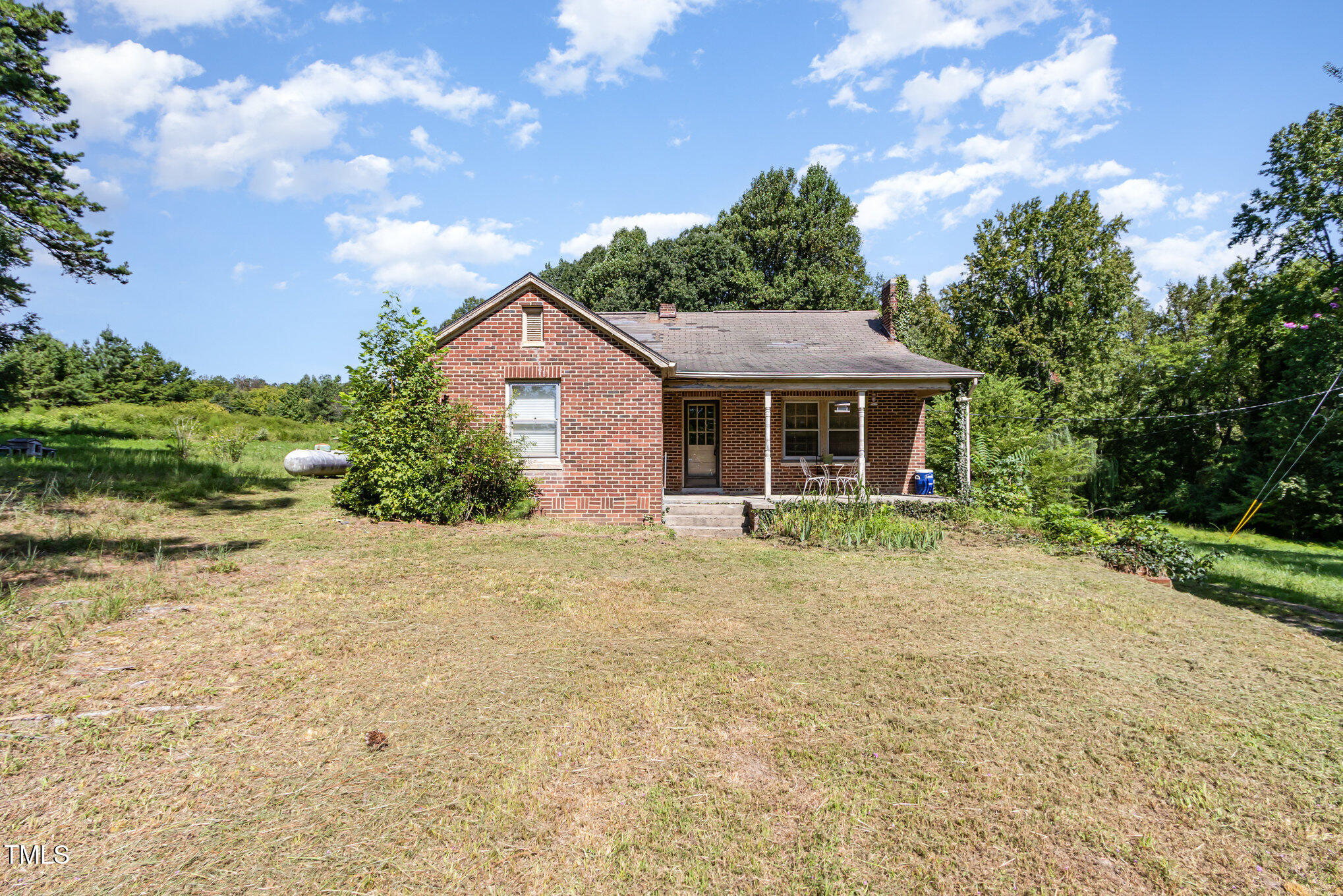 2089 Virgilina Road Roxboro, NC 27573 - Photo 1 of 32 a front view of a house with a garden