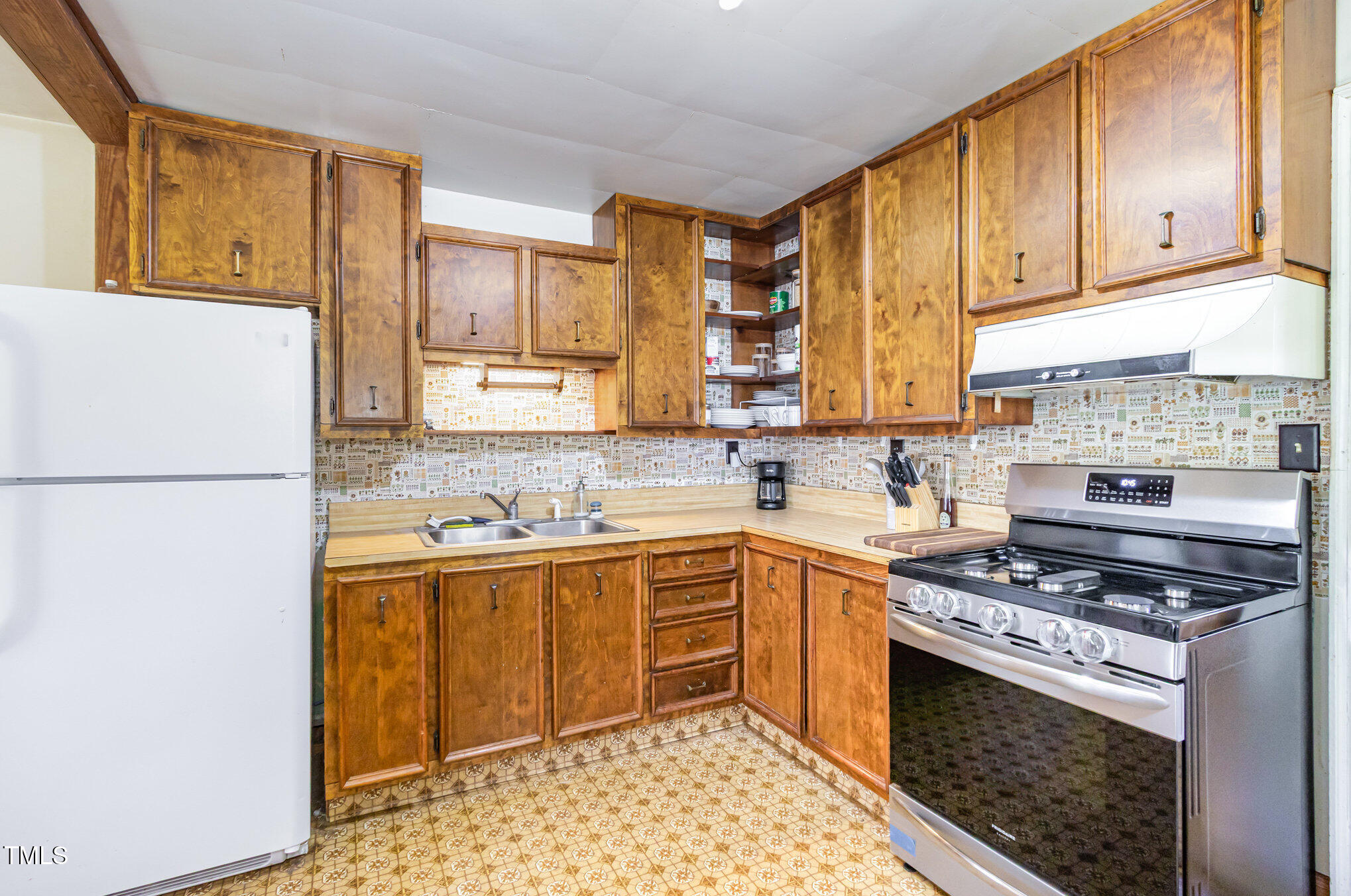 2089 Virgilina Road Roxboro, NC 27573 - Photo 13 of 32 a kitchen with a sink stove and cabinets