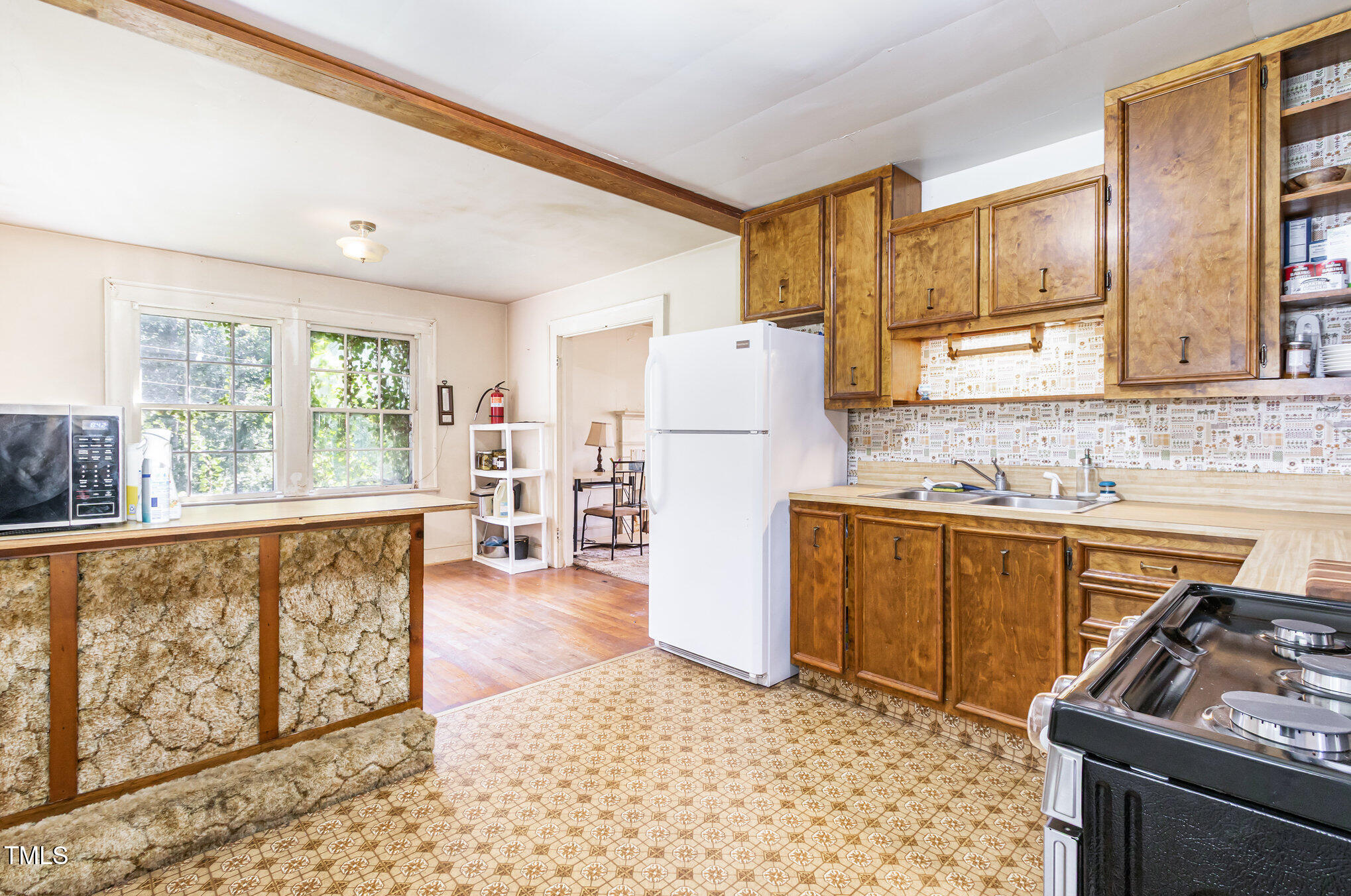 2089 Virgilina Road Roxboro, NC 27573 - Photo 14 of 32 a kitchen with granite countertop a refrigerator stove top oven and sink