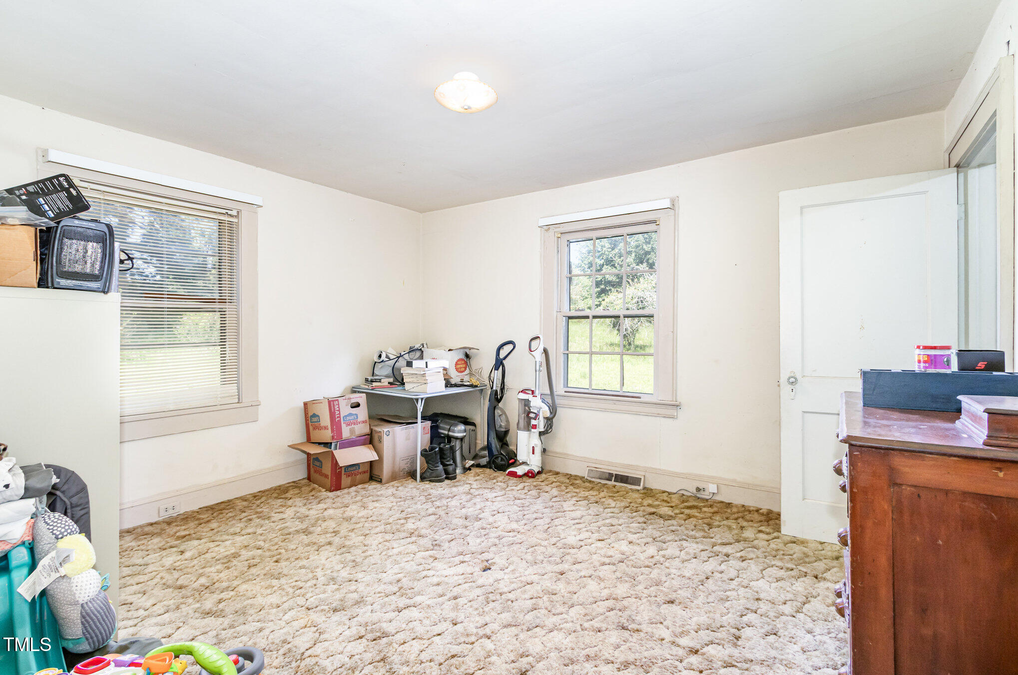 2089 Virgilina Road Roxboro, NC 27573 - Photo 20 of 32 a bedroom with a bed and wooden floor