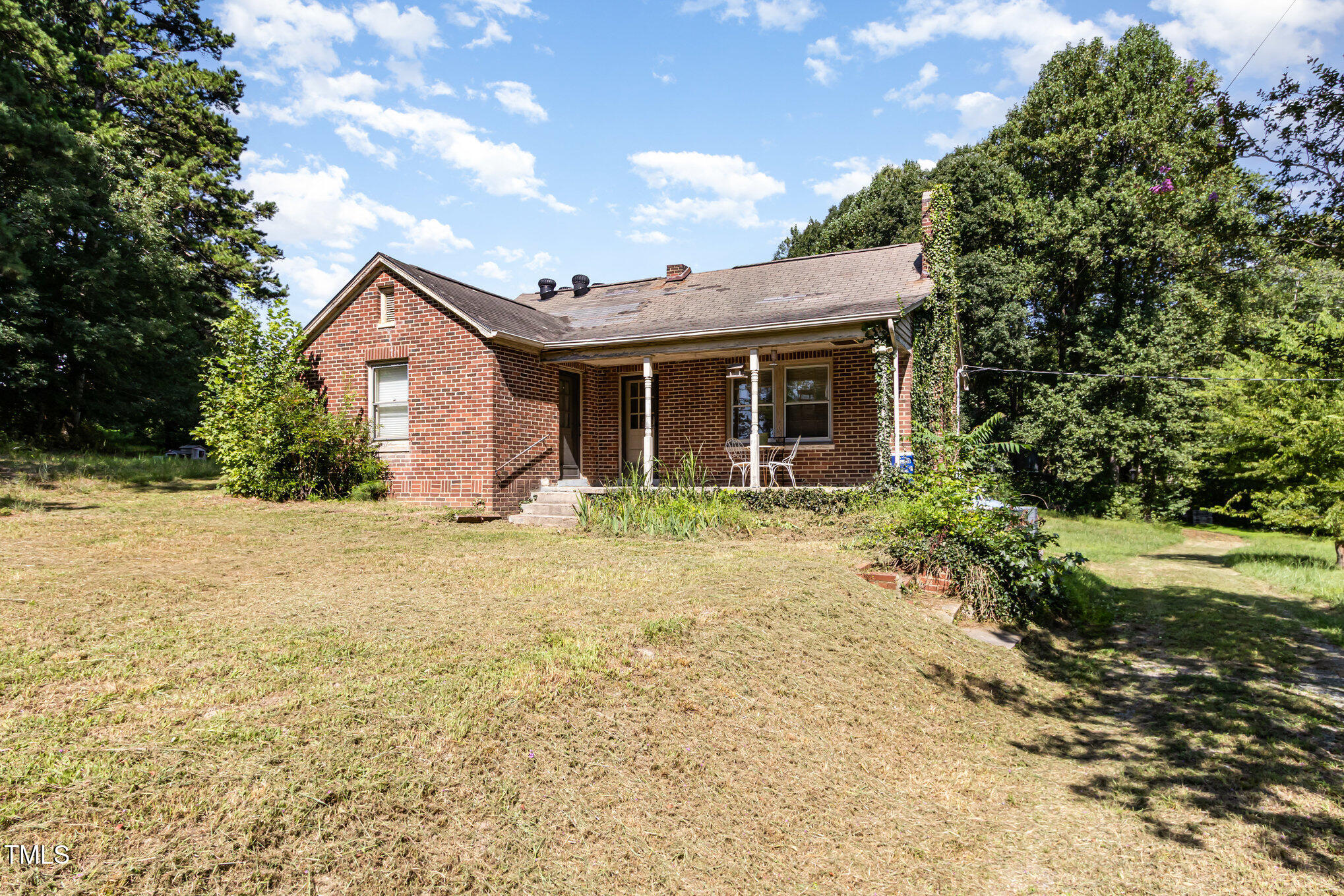 2089 Virgilina Road Roxboro, NC 27573 - Photo 2 of 32 a front view of house with yard and trees around