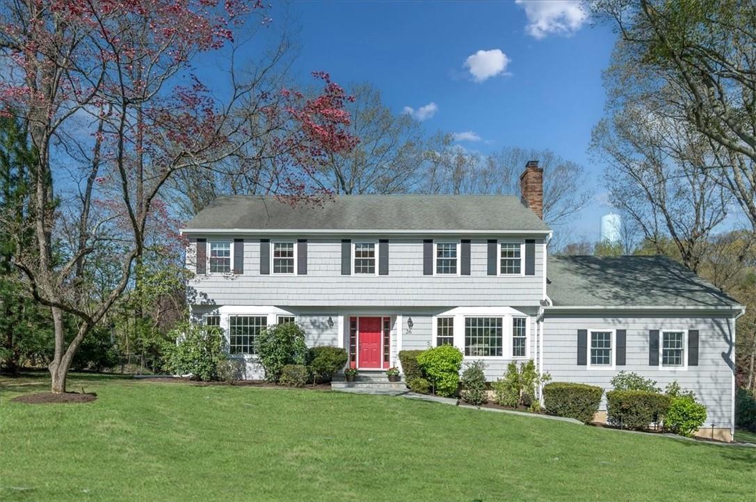 a front view of house with yard and green space