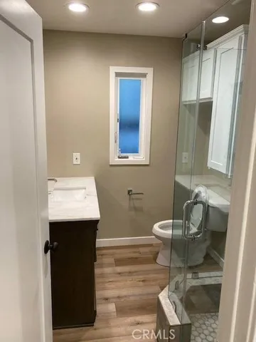 a bathroom with a sink toilet and mirror