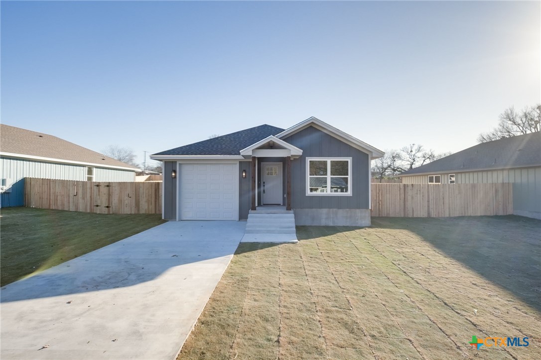 1208 Mill Street Gatesville, TX 76528 - Photo 1 of 28 a front view of a house with a yard and garage