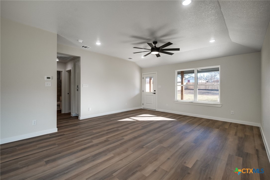 1208 Mill Street Gatesville, TX 76528 - Photo 5 of 28 a view of an empty room with a window and wooden floor