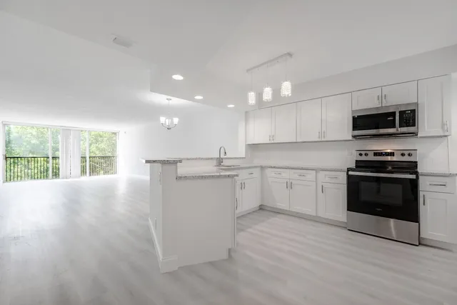 a kitchen with a white cabinets and appliances
