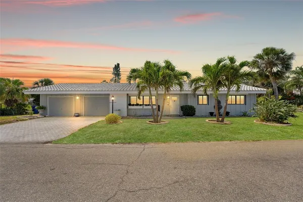 a front view of a house with a yard and a garage