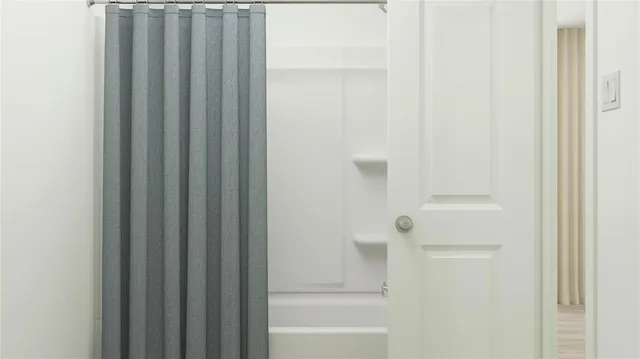 a bathroom with bathtub and shower