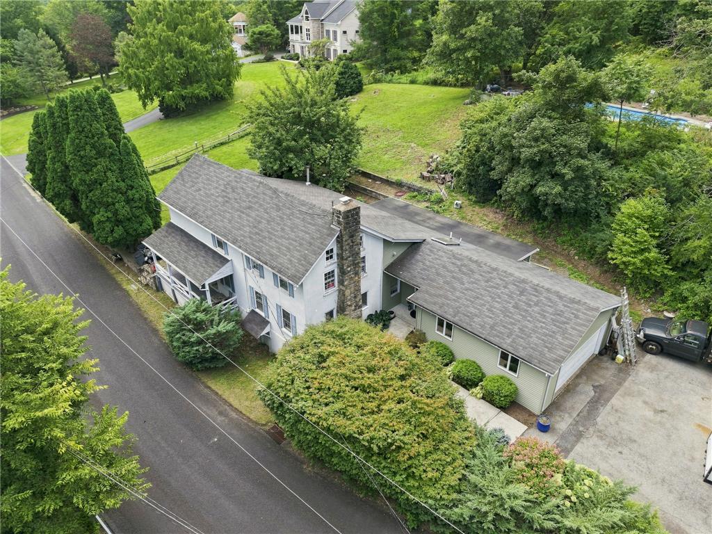 3408 Oak Hill Road Emmaus, PA 18049 - Photo 69 of 93 Aerial view reveals a multi-level country home bordered by mature trees and paved roadways.