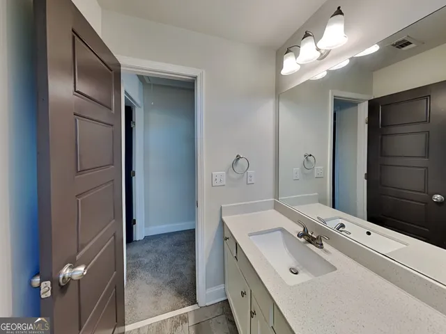 a bathroom with a double vanity sink mirror and shower