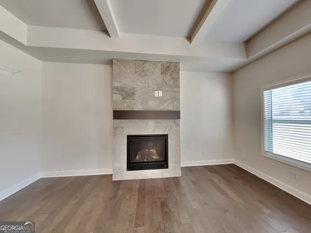 a room with a fireplace wooden floor and a window