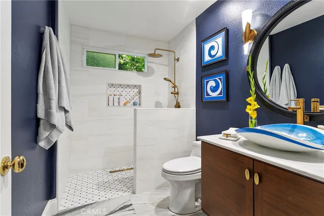 a bathroom with a sink a toilet and a mirror