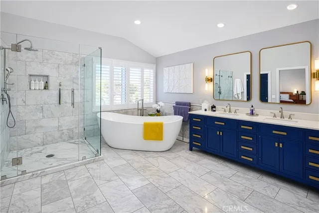 a spacious bathroom with a tub sink shower and mirror