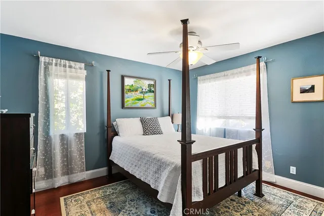 a bedroom with a bed a window and potted plant
