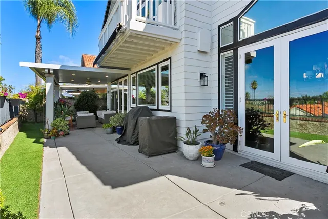 a view of a patio with table and chairs potted plants