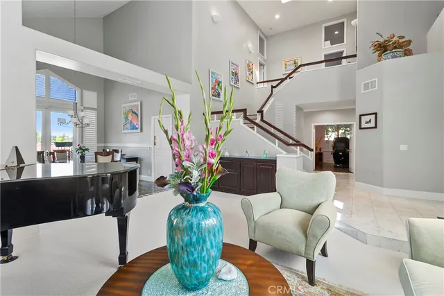 a living room with furniture potted plant and a chandelier