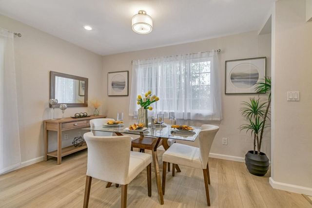 a view of a dining room with furniture and window