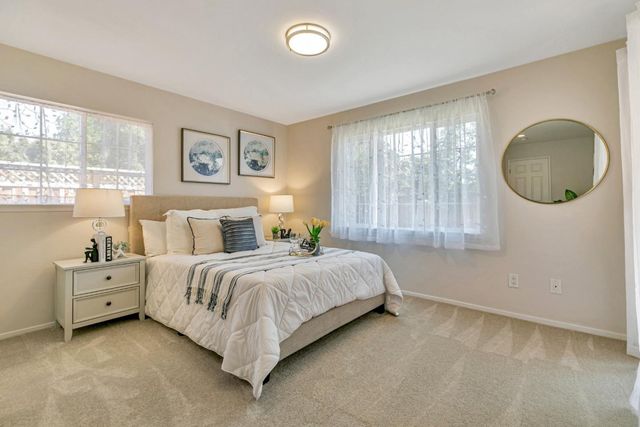 a spacious bedroom with a bed and a large window