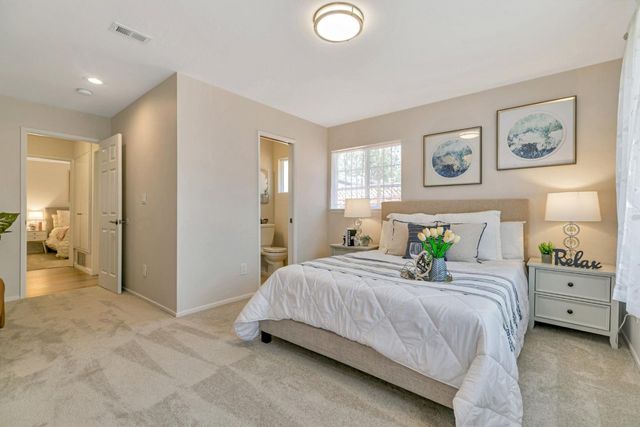 a bedroom with a bed and a lamp