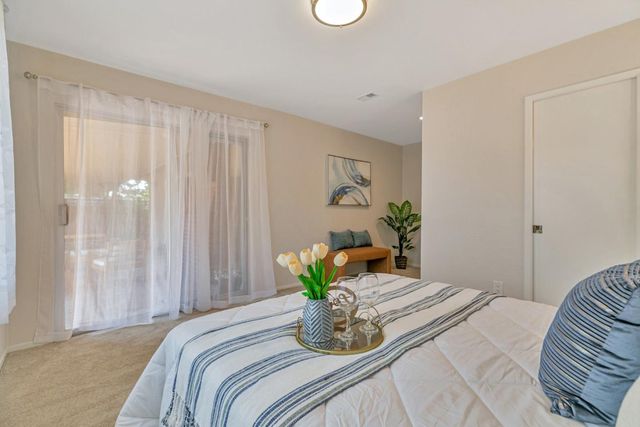 a bedroom with bed and a potted plant