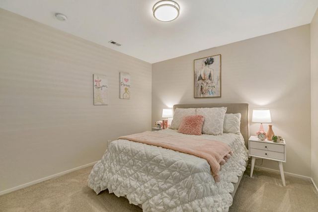 a bedroom with a bed and lamp