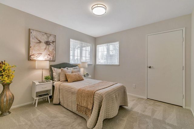 a bedroom with a bed and a painting on the wall