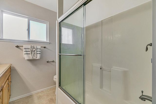 a bathroom with a shower and a sink