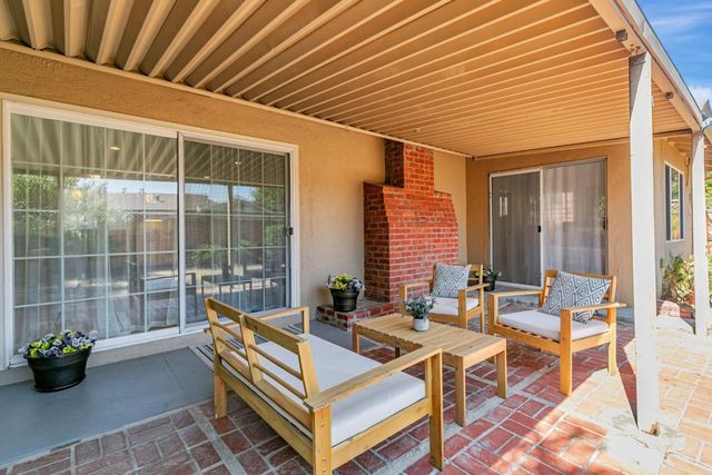 a building outdoor space with patio furniture and potted plants