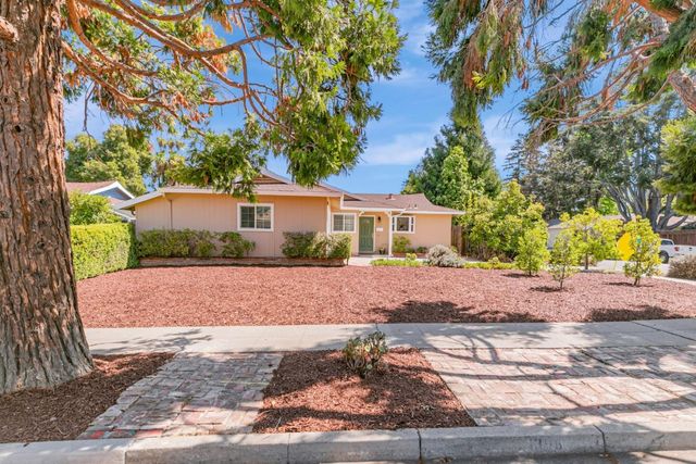 a front view of a house with a yard and a garage