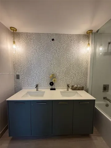 a bathroom with a double vanity sink and mirror